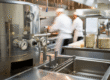 Industrial kitchen with stainless steel equipment and an integrated biodigester unit